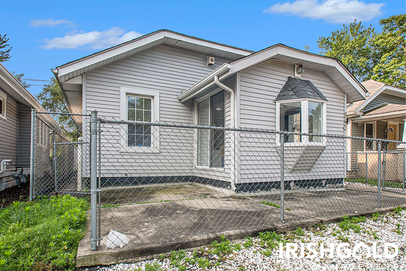 fenced in concrete slab attached to house